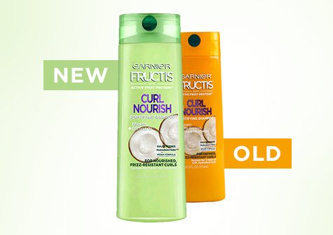 Garnier Fructis Curl Nourish Fortifying Shampoo in its new, green bottle stands in front of the same product but in the old, orange bottle against a light green background with the words NEW and OLD in green and orange blocks, respectively.